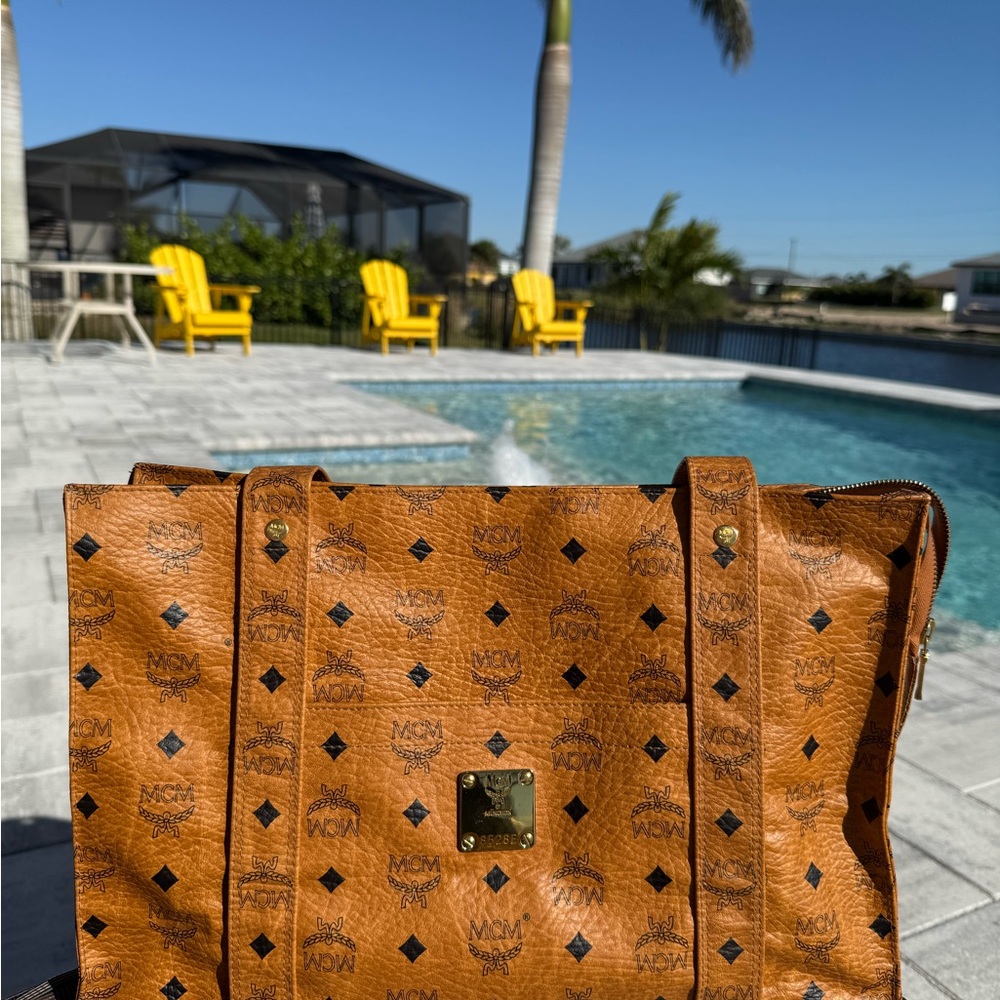 MCM Tan Perforated Leather Tote with Metal Clasp. Perfect condition.